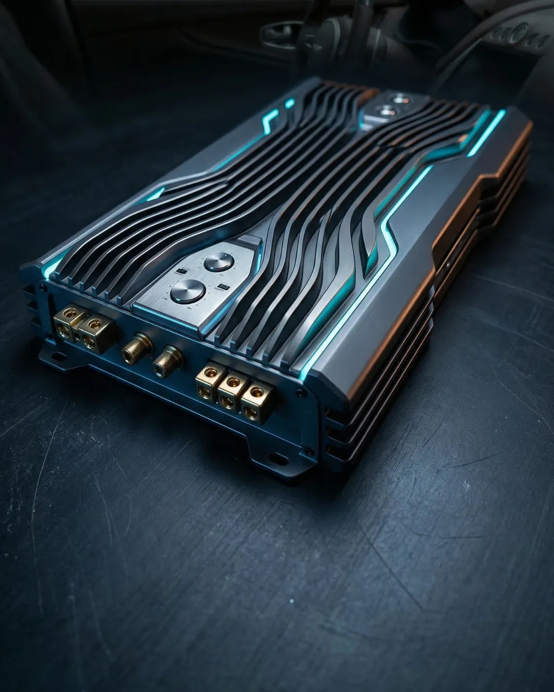 Sleek metallic car audio amplifier on a dark background.