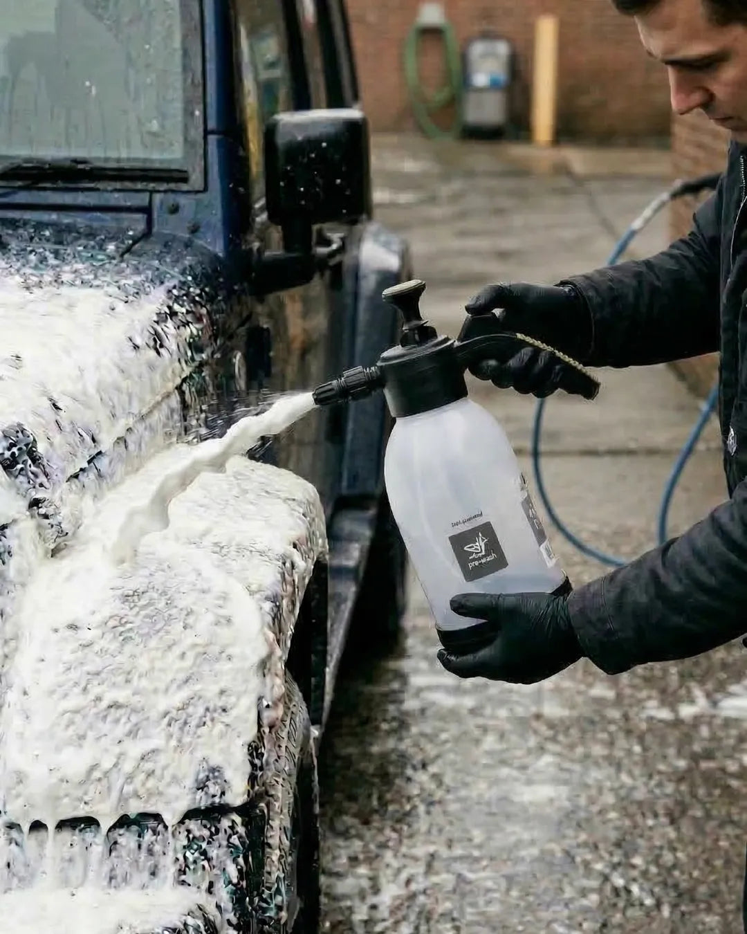 Heavy-duty brass snow foam lance spraying thick suds.